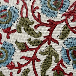 May include: A textile fabric featuring a repeating floral pattern with light blue petals, olive green leaves, and dark red stems on a white background. The material has a visible woven texture, showcasing a detailed botanical print design.