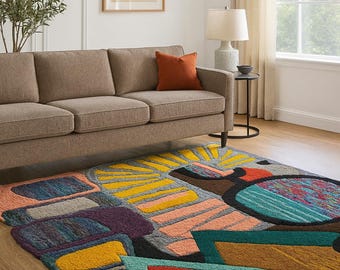 May include: A colorful area rug with an abstract design. The rug features a variety of shapes and colors, including yellow, orange, teal, purple, and black. The rug is placed on a hardwood floor in a living room setting.