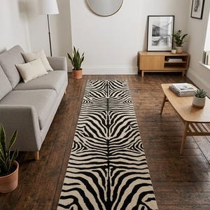 May include: A long, rectangular runner rug featuring a repeating black and cream zebra stripe pattern. The rug is positioned centrally on a dark wooden floor, displaying a symmetrical design that runs the entire length of the floor covering.