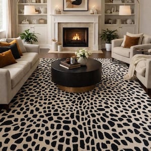 May include: A large area rug featuring a cream-coloured background with a repeating pattern of irregular, elongated black spots. The rug covers the floor of a living room, extending from the foreground towards a fireplace and seating area.