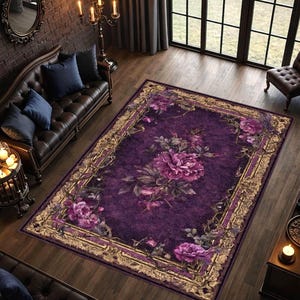 May include: A rectangular purple area rug with a floral design. The rug features large, detailed purple flowers and a gold border. The rug is placed on a hardwood floor in a living room setting.