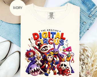 May include: Ivory-colored sweatshirt featuring a colorful graphic of cartoon characters with the text "THE AMAZING DIGITAL CIRCUS". The sweatshirt is a crew neck style and is made of a soft material.