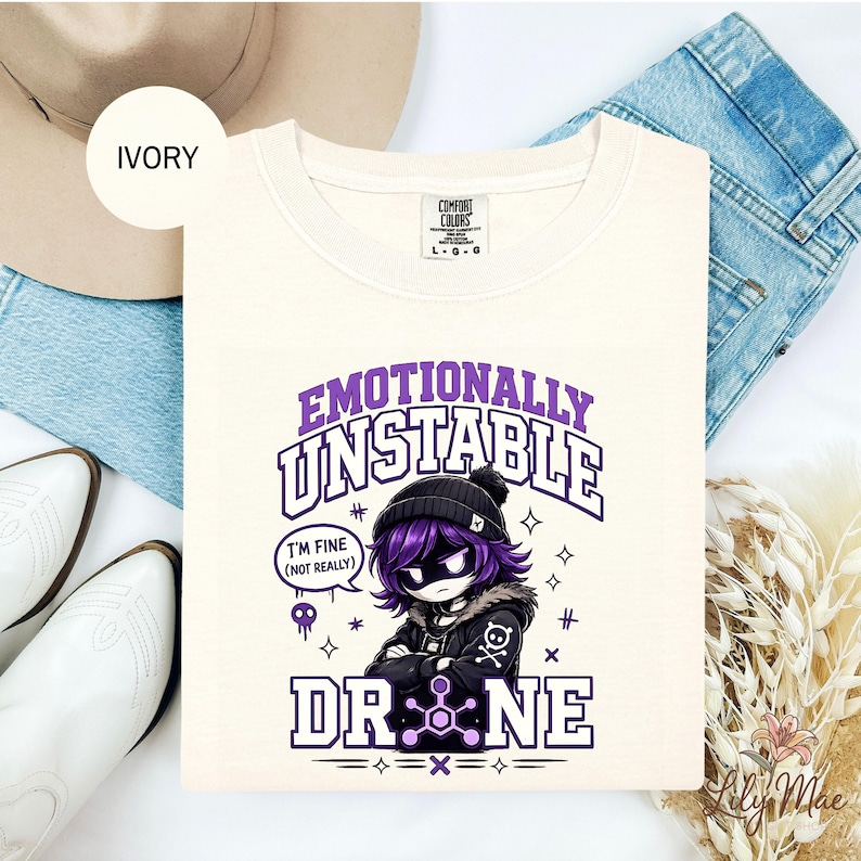 Purple and cream gothic collegiate style shirt design featuring an emo-inspired robot character with “Emotionally Unstable Drone” text.