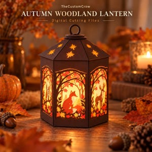 May include: A dark brown hexagonal lantern featuring intricate cutouts of a fox, a deer, and an owl within a forest scene. The lantern emits a warm glow and is topped with a circular handle. Text reads: TheCustomCrow AUTUMN WOODLAND LANTERN Digital Cutting Files.