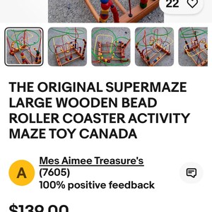 May include: A wooden bead roller coaster activity maze toy with colorful beads and wire tracks. The toy features a wooden base and frame with red, green, yellow, and blue wires. The text "THE ORIGINAL SUPERMAZE" is visible.