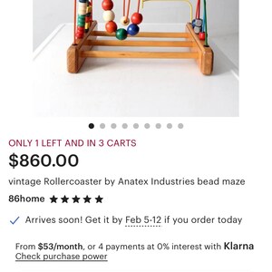 May include: A vintage wooden bead maze toy with colorful beads and wire tracks. The toy features red, yellow, green, and blue beads on a wooden base. A classic educational toy for children.