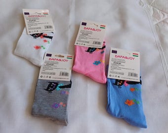 May include: Four pairs of crew socks in white, pink, gray, and blue, each featuring a black cat graphic with colorful flowers. Each pair includes a Dafa & Joy brand cardboard header card with product information and a barcode attached to the top.