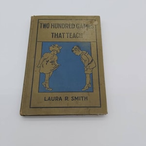 Livre, livre vintage deux cents jeux qui enseignent, 1923 livre amusant pour les enfants à l'ancienne, livre vintage or et bleu