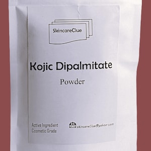 May include: A white pouch with the text "SkincareClue" and "Kojic Dipalmitate Powder." The pouch also includes the text "Active Ingredient Cosmetic Grade" and an email address.