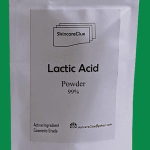 May include: A white packet with a label showing "SkincareClue" and the words "Lactic Acid Powder 99%." The label also states "Active Ingredient Cosmetic Grade" and an email address. The background is green.