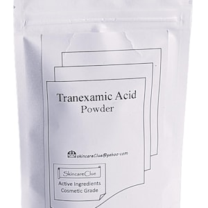 May include: A white, resealable pouch containing Tranexamic Acid Powder. The product label includes the text "Tranexamic Acid Powder", the email address skincareClue@yahoo.com, and the words "SkincareClue", "Active Ingredients", and "Cosmetic Grade".