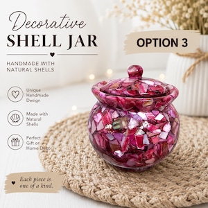 May include: A round jar with a lid, covered in small, iridescent magenta and pink shell fragments. The text on the image reads: Decorative SHELL JAR, OPTION 3, HANDMADE WITH NATURAL SHELLS, Unique Handmade Design, Made with Natural Shells, Perfect Gift or Home Decor, Each piece is one of a kind.