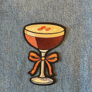 May include: A white ceramic mug with a black handle and the text "But First, Coffee" in a black, handwritten-style font. The mug is likely 11-15 ounces in size, perfect for a morning beverage.