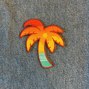 May include: A colorful palm tree patch with a sunset design. The patch features a vibrant orange and yellow sky, a yellow sun, and a turquoise and blue trunk. The patch is likely for clothing or accessories.