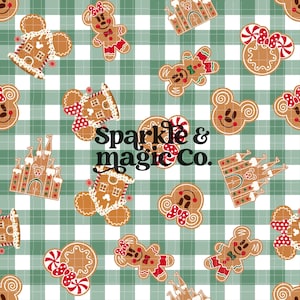 May include: A repeating pattern fabric featuring gingerbread-style cookies shaped like mouse ears, castles, and bows on a green and white gingham background. The text Sparkle & magic Co. is printed in black in the center of the design.