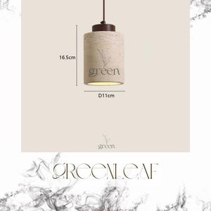 May include: A cylindrical pendant light with a beige textured finish, featuring the word "green" and a leaf design. The light fixture is 6.5 inches tall and 4.3 inches in diameter, with a brown top and a hanging cord.