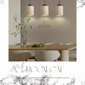May include: Three cylindrical pendant lights with beige shades and brown tops hang above a dining table. The word "green" is displayed on the wall. The image also includes the text "GREENLEAF" and "Indulge in luxury, nature-inspired home goods at exceptional prices- limited time only."