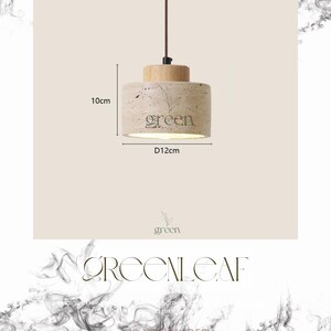 May include: A cylindrical pendant light with a wooden top and a textured, light-colored stone base. The base features the word "green" and a leaf design. The light fixture is 10cm tall and 12cm in diameter.
