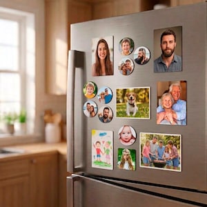 Puede incluir: Una colección de imanes fotográficos rectangulares y circulares expuestos en la puerta de un frigorífico de acero inoxidable. Los imanes muestran varios retratos de personas, parejas, familias, un perro y un dibujo infantil de dos figuras.