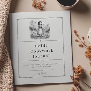 May include: A white journal with a black and white illustration of a girl in a mountain landscape on the cover. The text reads Heidi Copywork Journal, Literature-Based Copywork Journal for Young Writers, and Way of Wylder, framed by a decorative border.