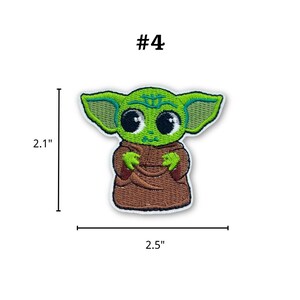 May include: Embroidered patch featuring a green alien character with large black eyes and pointed ears. The patch is 2.1 inches tall and 2.5 inches wide, with the number "#4" above the character.