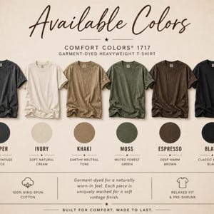 May include: A display of Comfort Colors 1717 garment-dyed heavyweight t-shirts in various colors. The available colors are pepper, ivory, khaki, moss, espresso, and black. The shirts are made of 100% ring-spun cotton and have a relaxed fit.