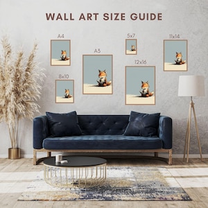 May include: A wall art size guide featuring six framed prints of a fox sitting on a sandy surface against a light blue background. The prints are labeled A4, A3, 5x7, 8x10, 11x14, and 12x16. The text WALL ART SIZE GUIDE is displayed at the top.