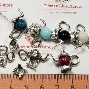 May include: Silver teapot charm beads with various colored gemstone beads. The beads are strung on a wire and are ready to be used in jewelry making.