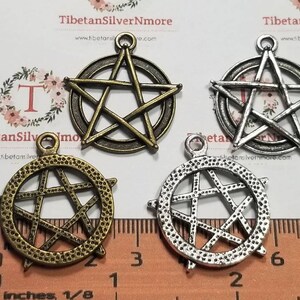 May include: Four silver and bronze pentagram charms with a textured finish. The charms are approximately 1 inch in diameter and have a loop at the top for hanging.