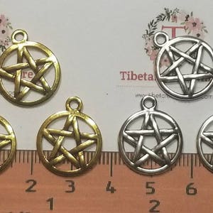 May include: Five silver and gold charms with a five-pointed star design. The charms are round and have a hole at the top for attaching to a necklace or bracelet.