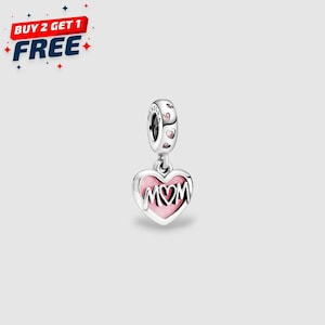 May include: A silver charm with a pink heart pendant that says "MOM" in silver lettering. The charm has a small loop at the top with pink accents. The image also includes the text "BUY 2 GET 1 FREE".