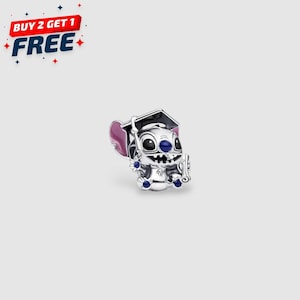 May include: A silver charm featuring the character Stitch from Lilo & Stitch, wearing a graduation cap and holding a scroll. The charm has blue and purple accents. The image also includes the text "BUY 2 GET 1 FREE".