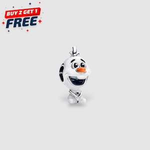 May include: A silver charm depicting Olaf from Frozen. The charm shows Olaf's smiling face with an orange carrot nose and a small twig on his head. The charm has a small body and the text "BUY 2 GET 1 FREE" in the upper left corner.