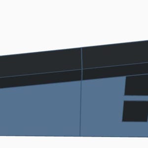 Puede incluir: Estructura geométrica azul y negra con techo inclinado. La estructura tiene varios recortes cuadrados y circulares negros. El diseño es simple y moderno, con líneas limpias y una estética minimalista.