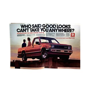 May include: A vintage advertisement for the Dodge Ram 50 pickup truck featuring the text WHO SAID GOOD LOOKS CAN'T TAKE YOU ANYWHERE? INTRODUCING THE NEW DODGE RAM 50. The red truck is parked on a wooden pier against a sunset sky with two figures nearby.