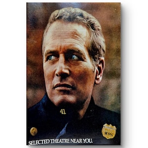 May include: A rectangular poster featuring a portrait of a man with light hair and blue eyes. He wears a dark uniform with a gold badge on the chest, the number 41, and a gold pin. The text at the bottom reads SELECTED THEATRE NEAR YOU.