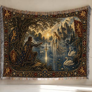 May include: A woven tapestry featuring a knight kneeling before a figure in a white gown standing in a lake with a glowing sword. The scene includes a castle, swans, and a decorative border with lion motifs, finished with a fringed edge.