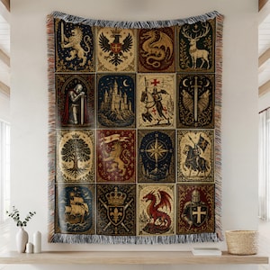 May include: A woven tapestry blanket featuring a grid of twelve medieval-themed panels. Illustrations include a lion, eagle, dragon, stag, knight, castle, sword, wolves, tree, compass, ship, and fleur-de-lis, finished with a fringed edge.