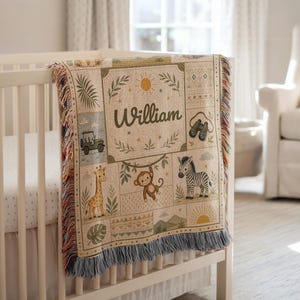 May include: A woven throw blanket featuring a jungle theme with the name William printed in the center. The design includes illustrations of a giraffe, a monkey, a zebra, a jeep, and binoculars, finished with a fringed edge on the bottom.