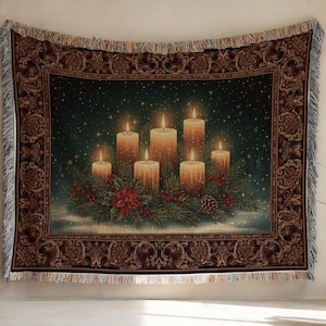 May include: A rectangular woven throw blanket featuring a dark green background with six lit pillar candles, pine branches, red berries, and a poinsettia. The blanket has a decorative brown border with ornate patterns and fringed edges on all sides.