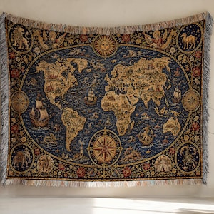 May include: A rectangular woven tapestry featuring a vintage-style world map in shades of navy blue and gold. The design includes a central sun, a compass rose, sailing ships, mythical sea creatures, and circular borders with animal illustrations.