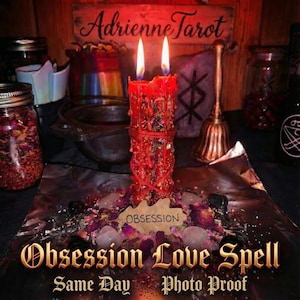 May include: A red candle with two lit flames, surrounded by rose petals and crystals. The candle is labeled "Obsession" and the text "Obsession Love Spell" is visible. Other items include jars, a bell, and a wooden sign that reads "Adrienne Tarot."