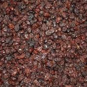 May include: A close-up view of a large quantity of dark brown raisins.