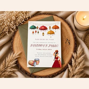 May include: A rectangular wedding invitation card featuring colorful hanging umbrellas and lanterns at the top, with text reading Sadi Kuri Da Viah, Savenna's Jaggo, Friday, July 4, 2029, and venue details, alongside illustrations of two drums and a person in a red dress.
