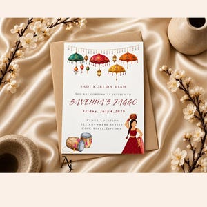 May include: A rectangular invitation card featuring colorful hanging umbrellas and lanterns at the top. The text reads SADI KURI DA VIAH, YOU ARE CORDINALLY INVITED TO SAVENNA'S JAGGO, Friday, July 4, 2029, and venue details. A person in a red outfit holds a pot.