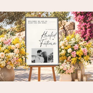A wedding welcome sign for Khalid and Fatima on a wooden easel, surrounded by large floral arrangements with yellow and pink flowers.