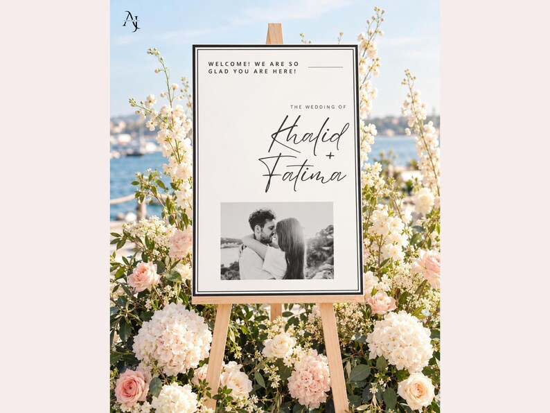 A wedding welcome sign for Khalid and Fatima on an easel outdoors with a water backdrop and abundant white and pink roses.