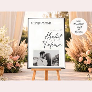 A wedding welcome sign on a wooden easel outdoors, featuring the text Khalid and Fatima and a couple's photo, with a text overlay showing available sizes.