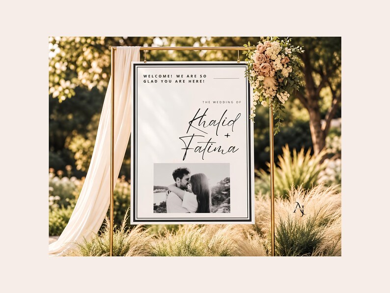 A wedding welcome sign for Khalid and Fatima suspended from a gold metal frame decorated with draping fabric and florals.