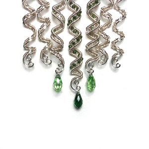 Handmade silver hair twist with customizable beads for braids.